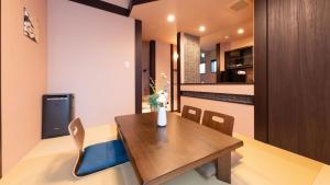 a kitchen and dining room with a wooden table and chairs at SYLA HOTEL 箱根強羅 West - SYLA HOTEL HAKONE GORA West in Gora