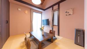 a dining room with a wooden table and chairs at SYLA HOTEL 箱根強羅 West - SYLA HOTEL HAKONE GORA West in Gora +41 photos