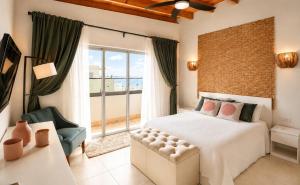 a bedroom with a large bed and a large window at Luxurious Ocean View Penthouse in Boca Chica