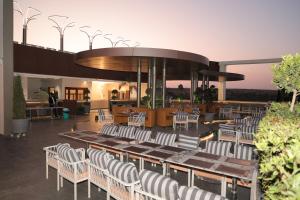 a restaurant with tables and chairs in a building at Hotel Sachin in Chas