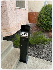 a parking meter sitting on the side of a building at Belle-Rive - family friendly Guest House in Edmonton