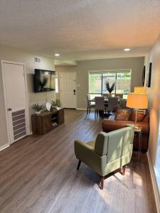 a living room with a couch and a chair at 2 King Suites w/ Private Baths + Workspaces | LSU in Baton Rouge