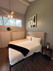 a bedroom with a large bed with a ceiling fan at 2 King Suites w/ Private Baths + Workspaces | LSU in Baton Rouge