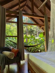 a bedroom with a bed and a large window at Dalakit House Villa Two in Siquijor +21 photos