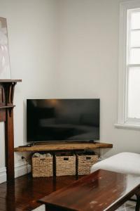 a living room with a large flat screen tv at Heritage Hideaway in Bunbury
