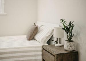 a bedroom with a bed with a plant on a table at Heritage Hideaway in Bunbury +7 photos