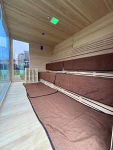 a large empty room with benches in a building at 御宿ガーデンヴィラ in Onjuku