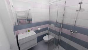 a bathroom with a toilet and a glass shower at Go Native Prague Apartment in Prague