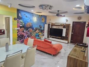 a living room with a couch and a television at Sunstar in Coimbatore