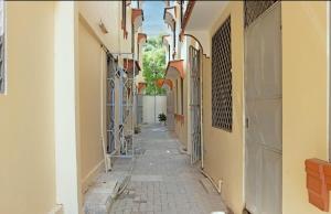 an empty alleyway in an old building with a hallway at House Stark in Kilifi