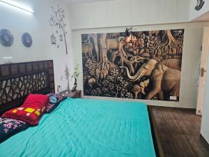 a bedroom with a large painting on the wall at Sunstar in Coimbatore