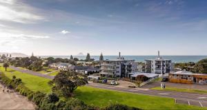 an aerial view of a city with the ocean at Ohope Beach Resort in Ohope Beach