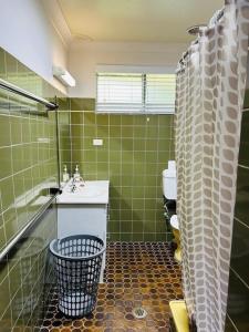 a bathroom with a sink and a toilet and a shower at Stouty's at Hat Head - No Sheets or Towels Provided in Hat Head +18 photos