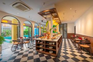 a restaurant with a checkered floor and tables and chairs at BACKHOME BOUTIQUE Old Town Hoi An in Hoi An