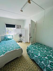 a bedroom with a bed and a window at Bonnydoon at Hat Head - 5 Oak Street in Hat Head