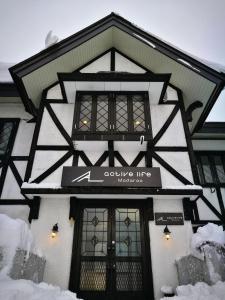 a building with a sign for a couture inc store at Active Life Madarao in Iiyama