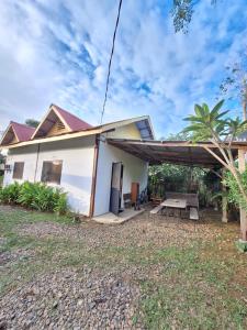 a house with a picnic table in front of it at Lio House 2 bedroom in El Nido Airport