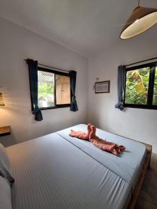 a bedroom with a bed with a stuffed animal on it at Lio House 2 bedroom in El Nido Airport