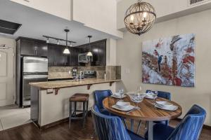 a kitchen and dining room with a table and chairs at The Eagle Suite at Stoneridge Mountain Resort in Canmore