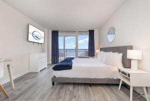 a bedroom with a bed and a view of the ocean at Spacious Beach Condo Double Suite for Couples Getaway in Myrtle Beach +55 photos