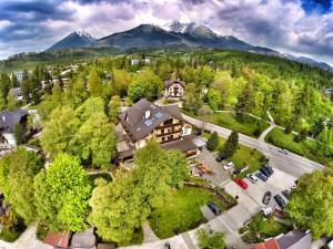 an aerial view of a house with mountains in the background at Penzión Slalom in Vysoke Tatry - Tatranska Lomnica.