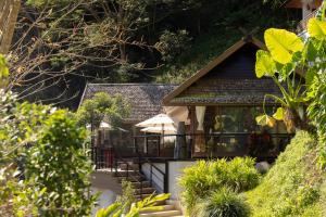 a house with a porch and a balcony at J Valley Resort in Pong Yaeng