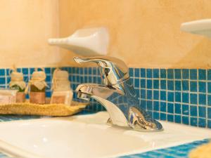 a bathroom sink with a silver faucet on it at Hotel Barrio Latino in Playa del Carmen +41 photos
