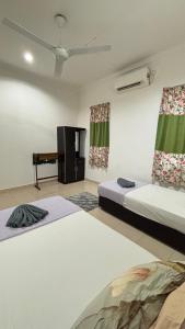 a room with two beds and a table in it at Ayem Resort Langkawi in Air Hangat +31 photos