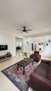 a living room with a couch and a table at Ayem Resort Langkawi in Air Hangat
