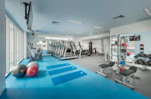 a gym with a blue floor and tread machines at PARKROYAL Parramatta in Sydney