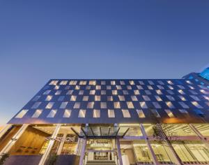 a building with a blue and white facade at PARKROYAL Parramatta in Sydney