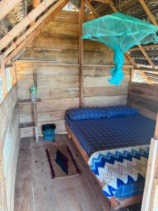 a room with a bed in a wooden house at Wana beach camp in Raddela +28 photos