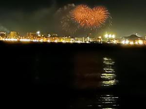 a fireworks display over the water with a city in the background at Bari Sea Paradise View in Bari