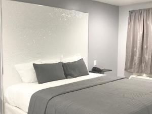 Säng eller sängar i ett rum på Ramsey Inn & Suites