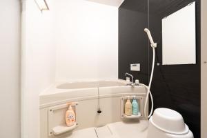 a bathroom with a toilet and a bath tub at S-villa Nasu 12th in Nasu-yumoto +20 photos