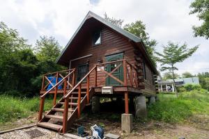 a log cabin with a staircase leading up to it at S-villa Nasu 12th in Nasu-yumoto