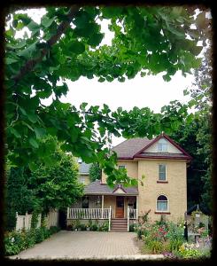 a large house with a driveway in front of it at Tranquil Days Guest House ---- Arbour Garden in Stratford