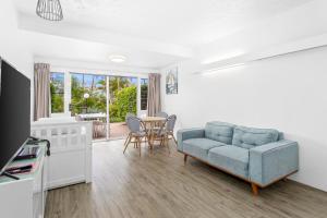a living room with a couch and a table at Rosslyn Bay Resort Yeppoon in Yeppoon