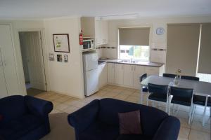 a kitchen and living room with a table and chairs at Tooleybuc River Retreat Villas in Tooleybuc