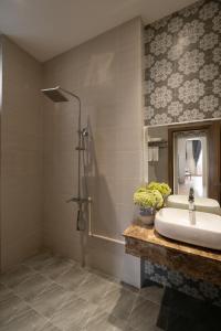 a bathroom with a sink and a shower at Gold View Boutique Hotel Đà Lạt in Da Lat