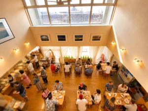 a group of people sitting at tables in a building at Hotel Lavenir in Biei +10 photos