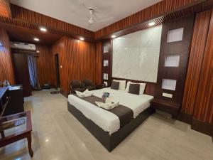 a bedroom with a large bed and a large screen at Hotel The King's in Port Blair +43 photos