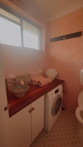a bathroom with a washing machine on a counter at Le Maroc at Bar Beach in Newcastle