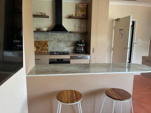 a kitchen with two stools and a counter top at Le Maroc at Bar Beach in Newcastle