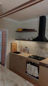 a kitchen with a stove and a counter top at Le Maroc at Bar Beach in Newcastle +3 photos