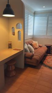 a living room with a couch in the corner at Le Maroc at Bar Beach in Newcastle