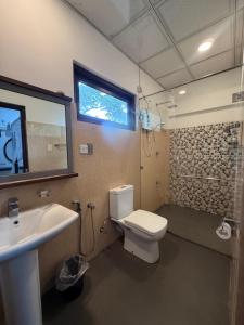a bathroom with a toilet and a sink and a shower at Tanzanite place in Tangalle +132 photos
