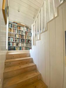 a staircase in a house with bookshelves at Architect-Designed House With Pier In Ny Hellesund in Søgne