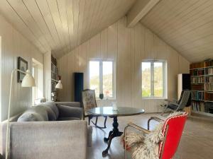 a living room with a couch and a table at Architect-Designed House With Pier In Ny Hellesund in Søgne