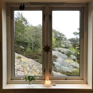 a window with a candle and a window with a view at Architect-Designed House With Pier In Ny Hellesund in Søgne
